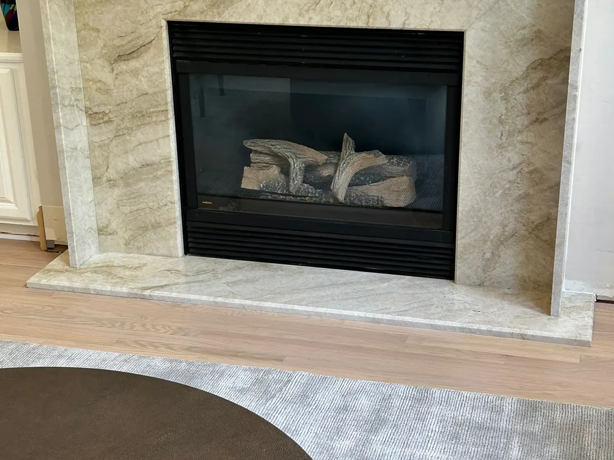 Quartzite fireplace surround and hearth above a wood floor