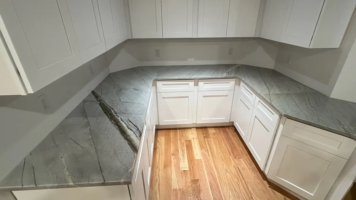 L-shaped stone countertop turning the corner of a kitchen
