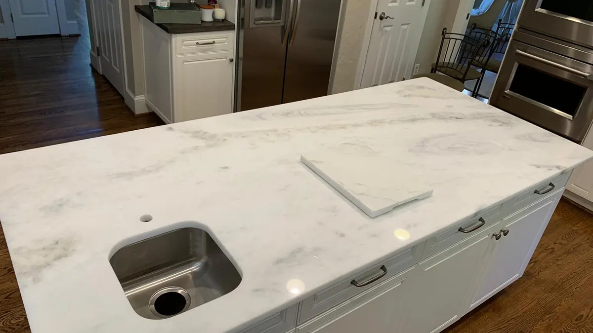 Close-up of a white natural stone countertop with soft gray veins
