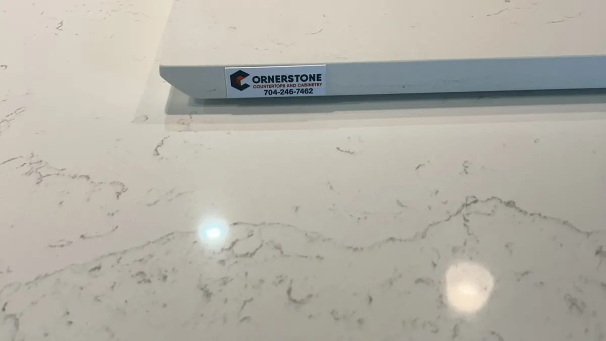 Close-up of a white quartz countertop with a Cornerstone label