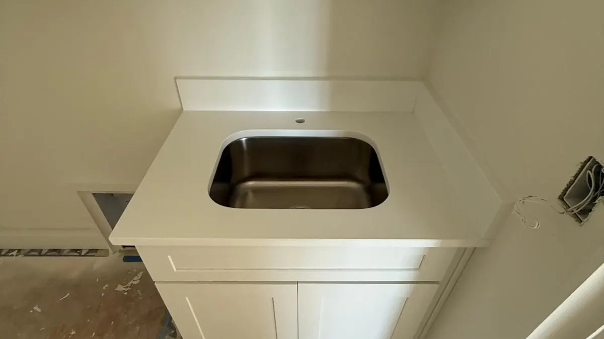 Small white stone vanity top with an undermount sink