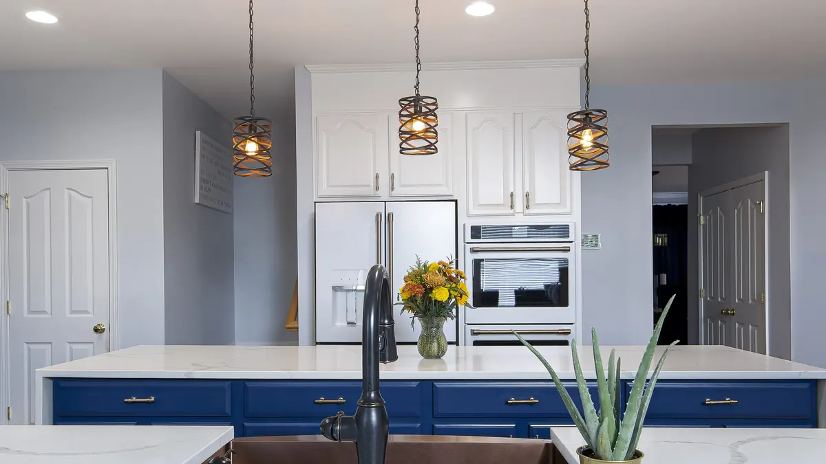Kitchen with an island sink facing the range and refrigerator