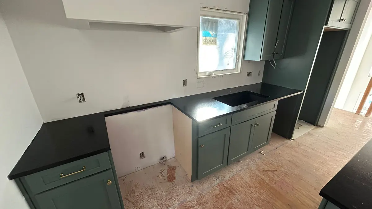 Kitchen with new cabinets and part of the countertop installed