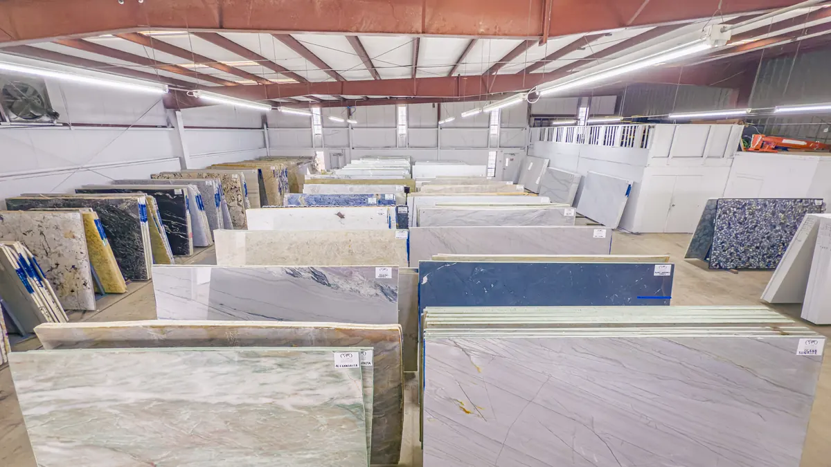 Light and dark countertop slabs side by side in the Cornerstone slab yard