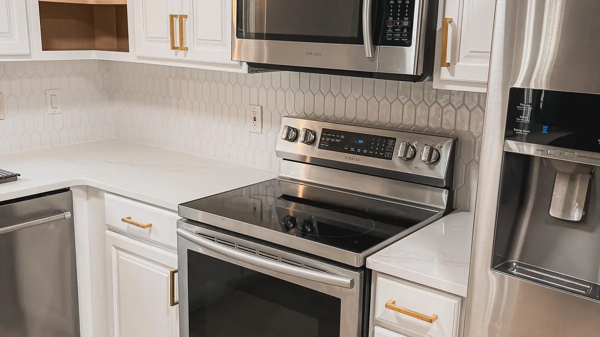 White shaker kitchen cabinets with brass pulls