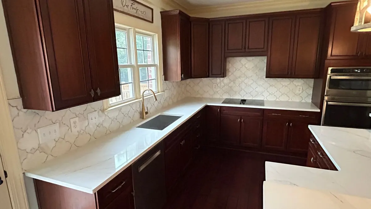 Arabesque tile backsplash above a white quartz countertop
