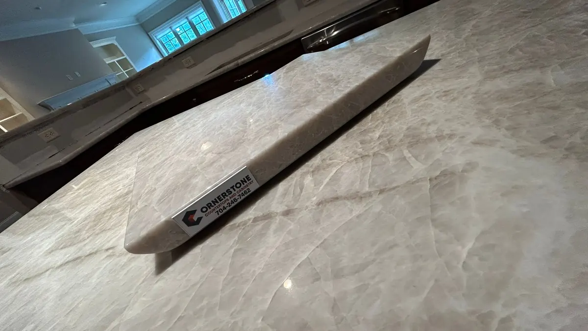 Warm white quartzite countertop with soft taupe veins