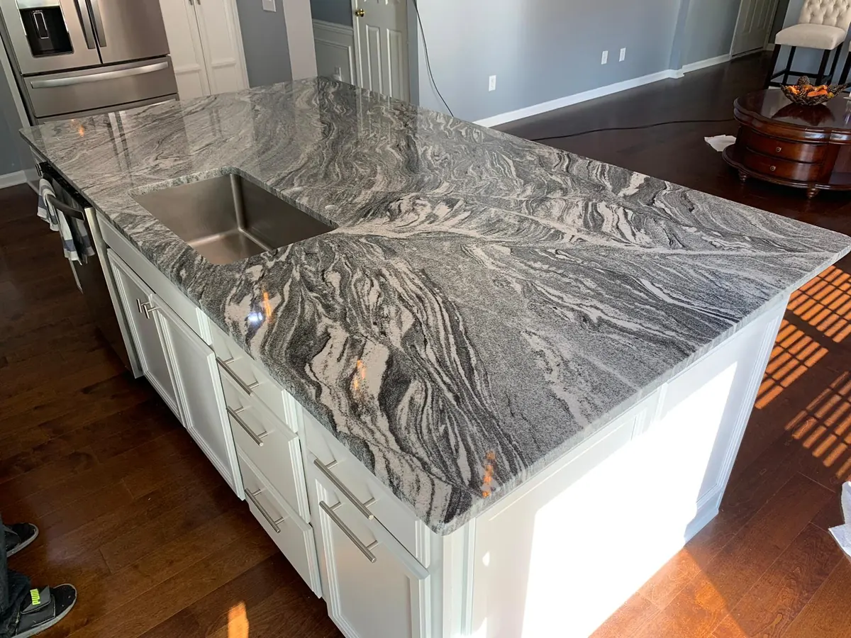 Granite countertop with bold, swirling movement in dark and light tones