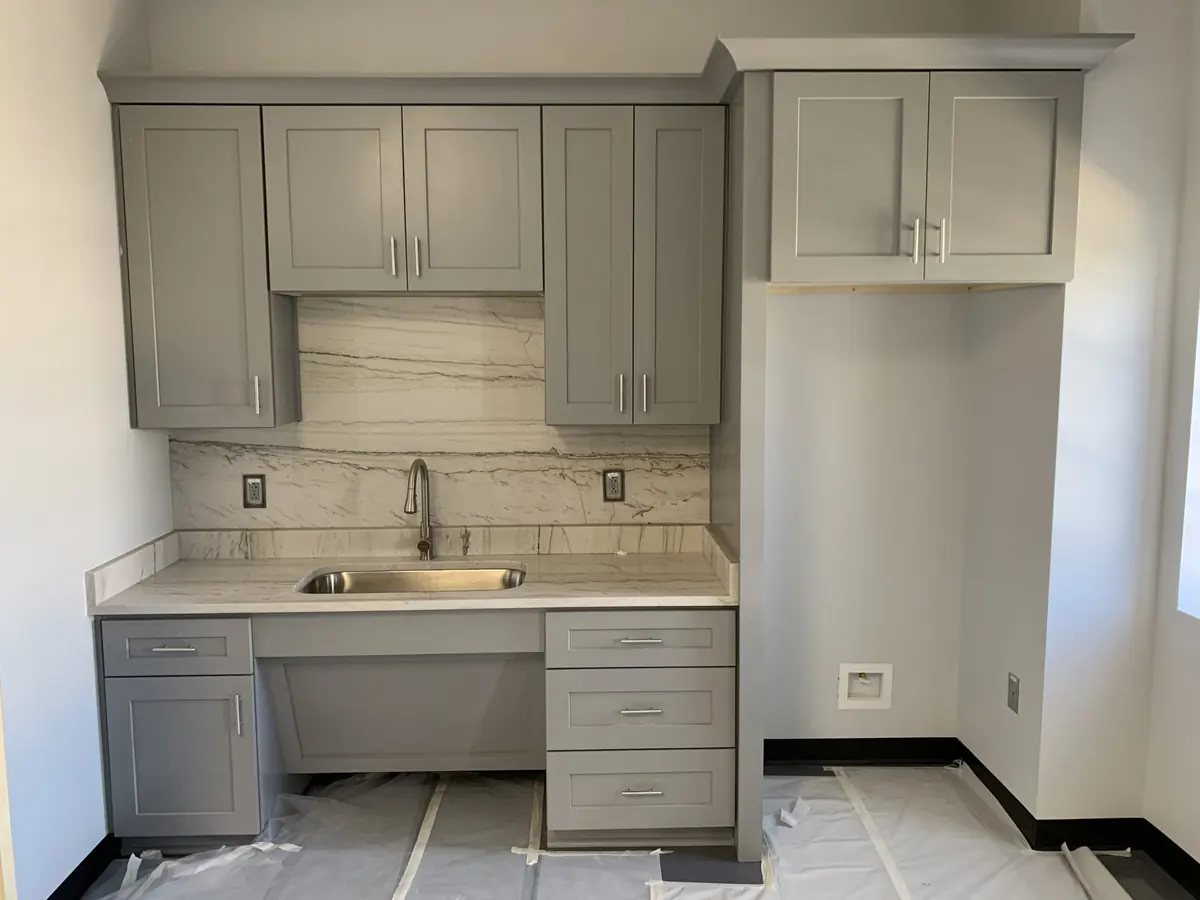 New gray kitchen cabinets with a white quartz countertop