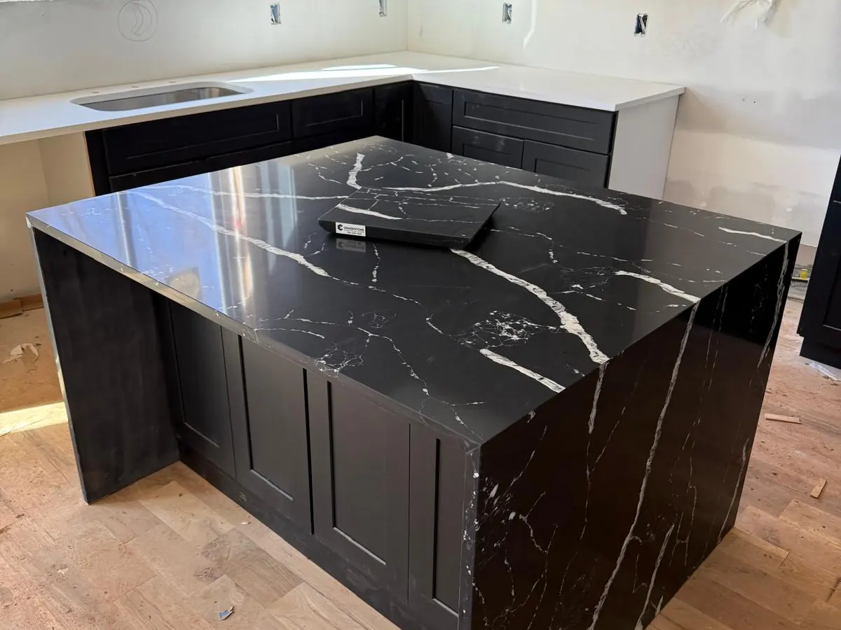 Black stone kitchen island with waterfall sides and white veining