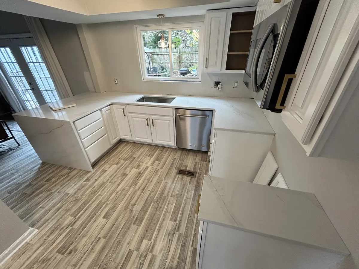 White quartz kitchen countertops with a waterfall end and white cabinets
