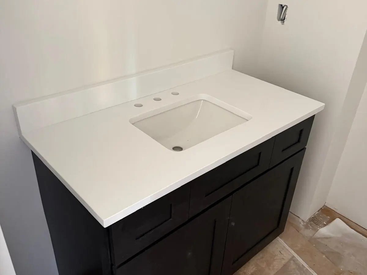 Single bathroom vanity with a white stone top