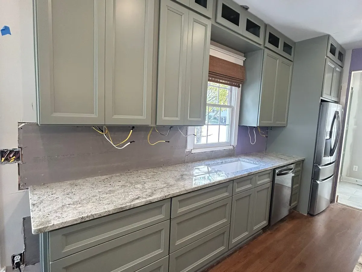Green kitchen cabinets with granite countertops