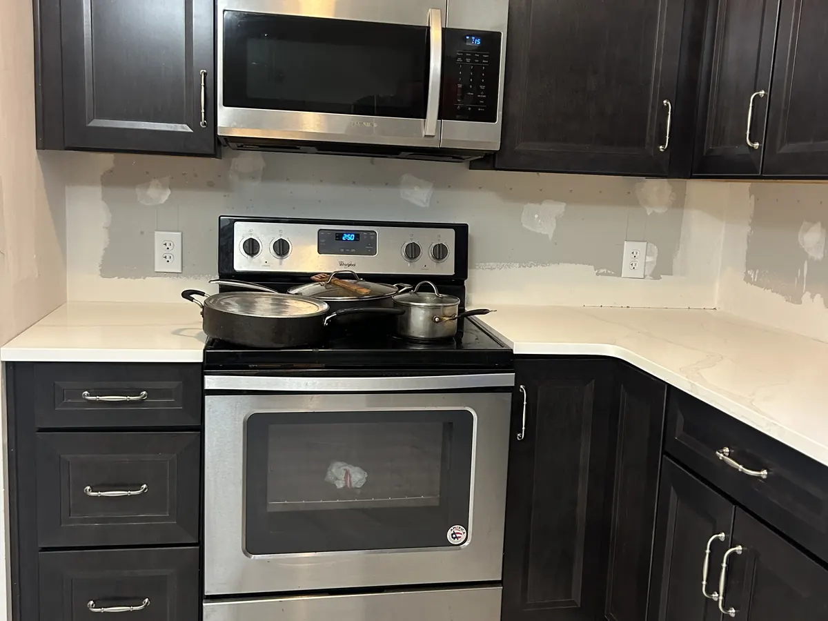 Dark shaker kitchen cabinets with a white countertop