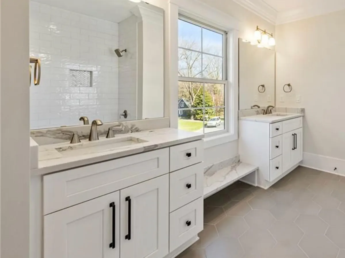 Bathroom with gray hexagon porcelain floor tile and white shaker vanities