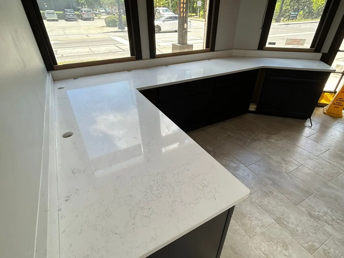 New white stone countertop installed along a window